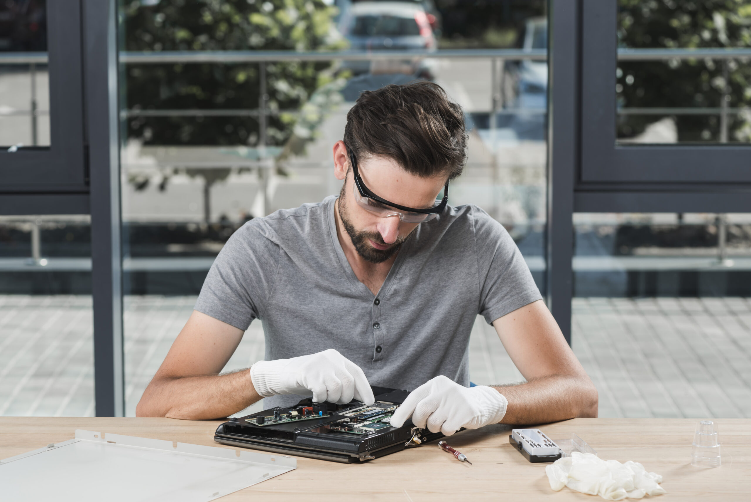 young-male-technician-repairing-computer-workshop